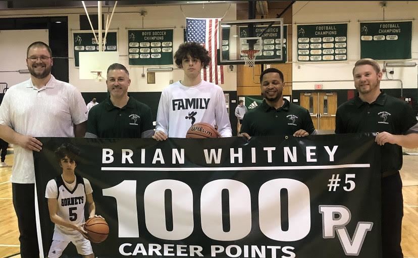 Brian Whitney (center) after scoring his 1,000th point